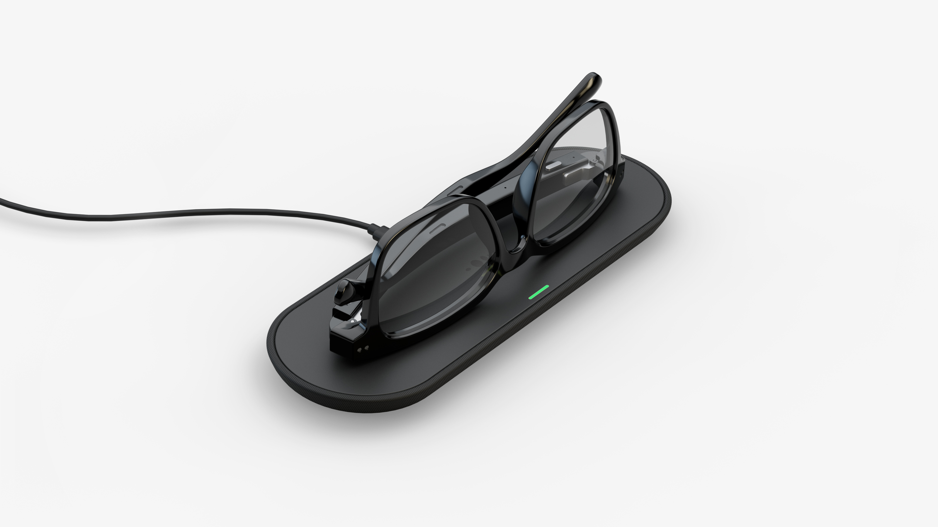 Nuance Audio hearing glasses resting on wireless charging pad